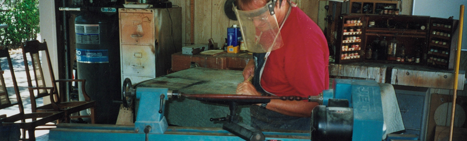 Philippe refinishes a fine furniture piece on the lathe.